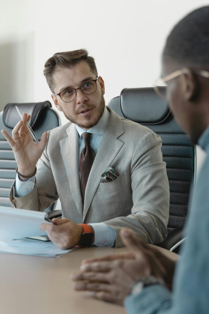 pexels photo 5439438 5439438 Two businessmen engaged in a professional meeting in a modern office setting.